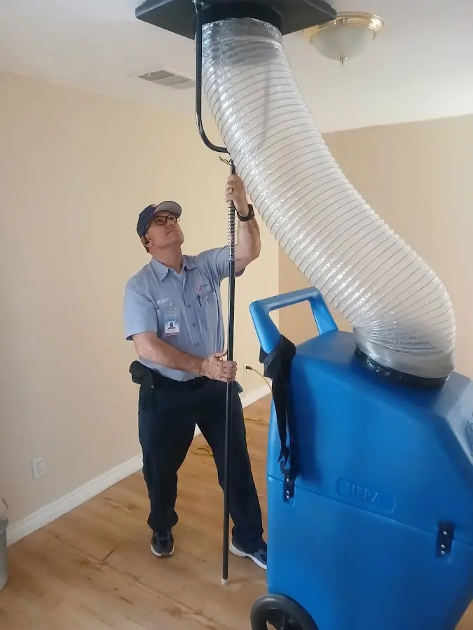 Furnace Tune-Up technician using HEPA equipment in Bartow